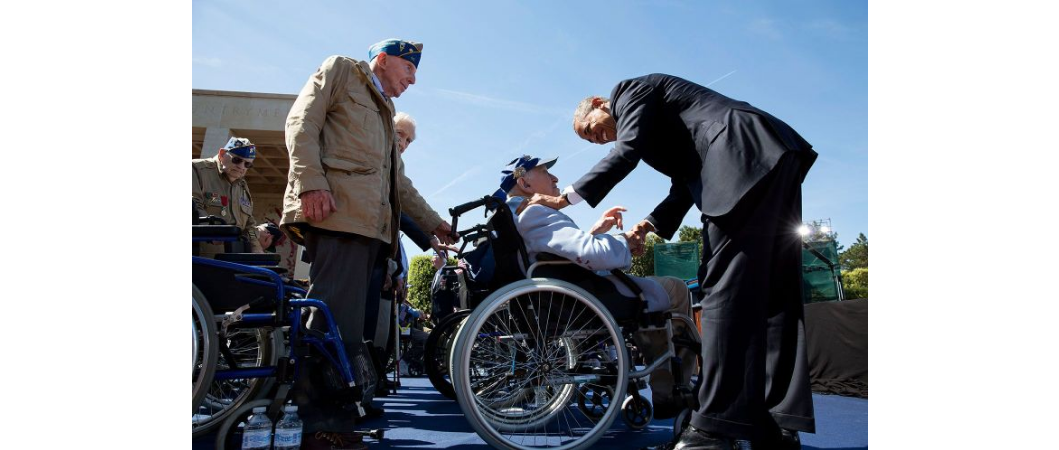 President Obama greets veteran on stage for the 70th anniversary