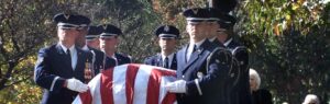 image of soldiers carrying a coffin draped in an American flag