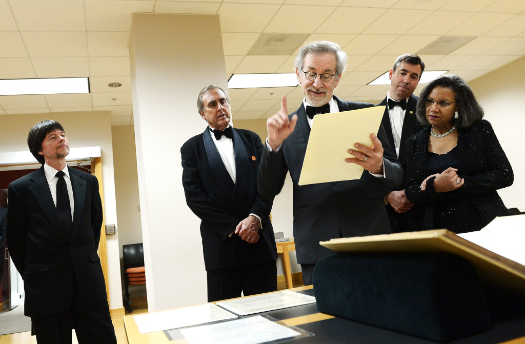 Filmmaker and honoree Steven Spielberg (C) reads from Rep. Thaddeus Stevens'  handwritten joint resolution of December 9, 1861 proposing the abolition of slavery, as Foundation for the National Archives Board Vice President and Gala Chair Ken Burns (L), Executive Director of the Foundation for the National Archives Patrick Madden (2nd R), and Foundation for the National Archives Chair and President A'Lelia Bundles (R) look on at the Foundation for the National Archives 2013 Records of Achievement award ceremony and gala in honor of Steven Spielberg on November 19, 2013 in Washington, D.C. (Photo by Michael Loccisano/Getty Images for Foundation for the National Archives)