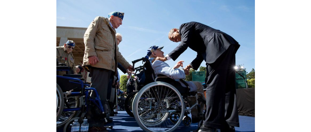 President Obama greets veteran on stage for the 70th anniversary