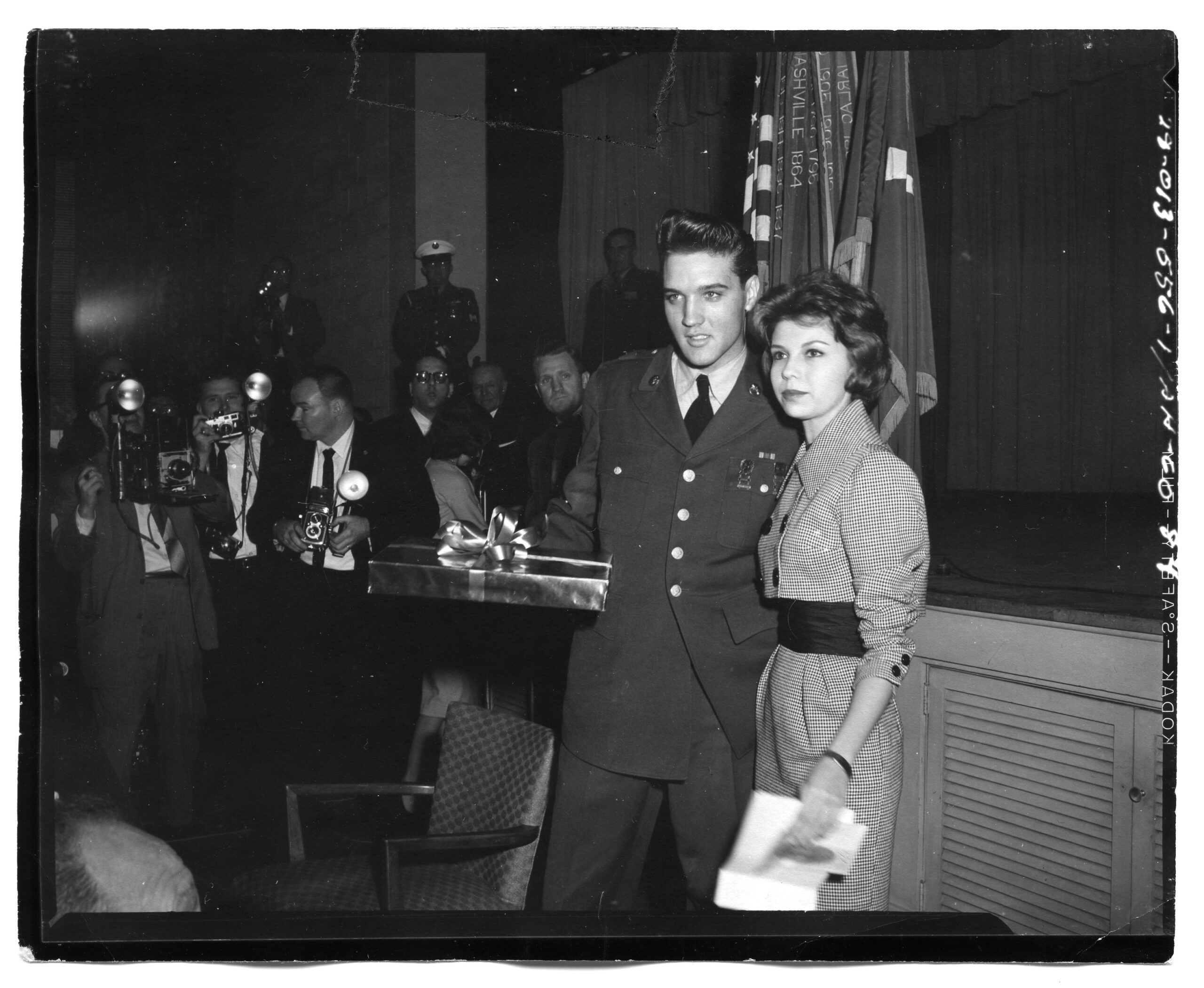 Sergeant Elvis Presley receives a gift from Nancy Sinatra, daughter of Frank Sinatra