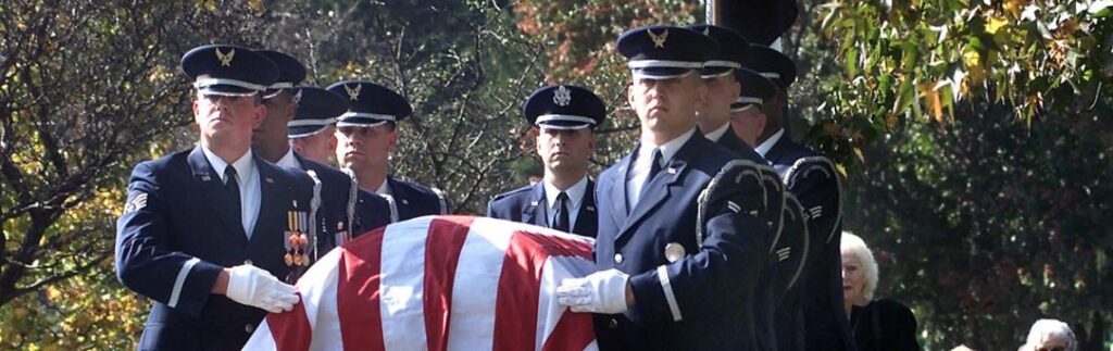 image of soldiers carrying a coffin draped in an American flag